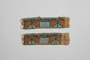 Image of beaded cuffs, pair, with blue, orange-brown pattern